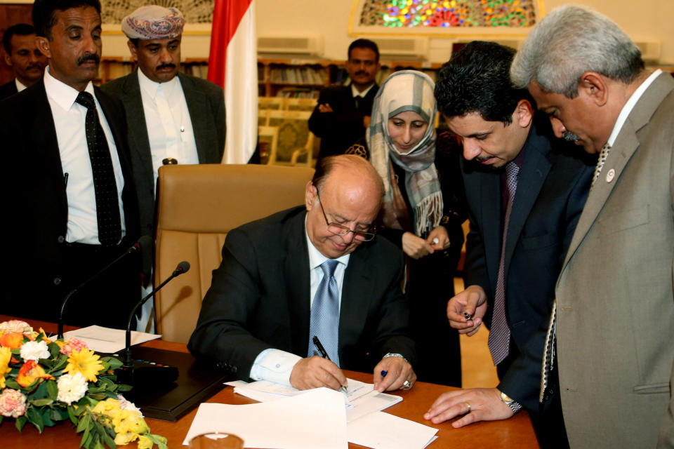 In this photo provided by Yemen's Defense Ministry, Yemeni President Abed Rabbo Mansour Hadi signs the final approval on transforming Yemen into a federal state of six regions in Sanaa Yemen, Monday, Feb. 10, 2014. A key Yemeni panel tasked with devising a new system to address the local grievances that have fed the impoverished Arabian Peninsula nation's instability agreed Monday to transform the country into a state of six regions. (AP Photo/Yemen's Defense Ministry)