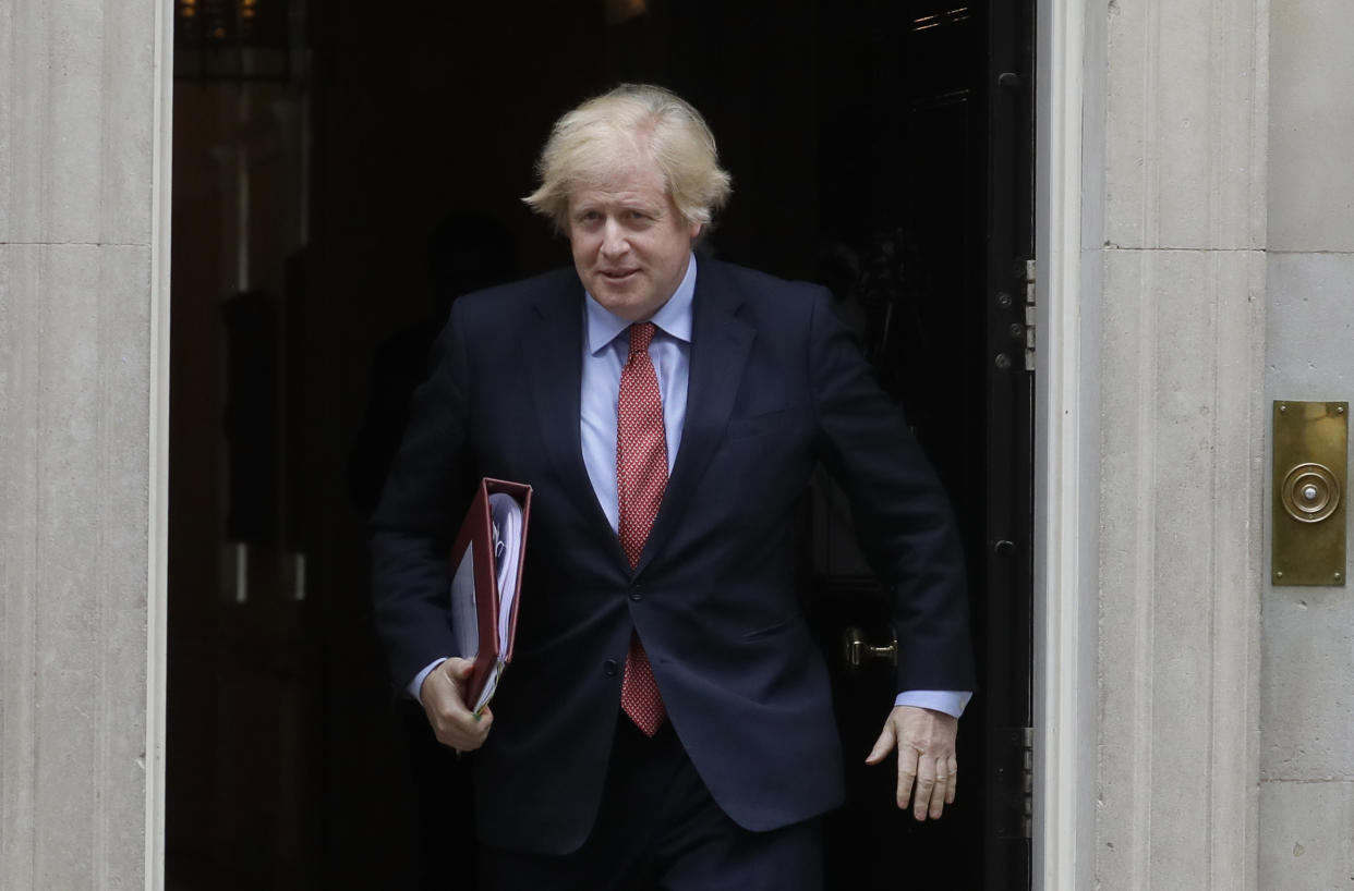 Britain's Prime Minister Boris Johnson leaves 10 Downing Street to attend the weekly session of PMQs in Parliament in London, Wednesday, June 10, 2020. (AP Photo/Kirsty Wigglesworth)