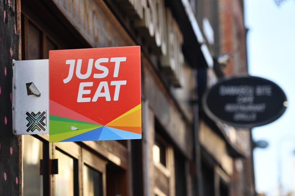 A sign for Just Eat, a food delivery service can be seen above a restaurant in London on December 18, 2017. Photo: BEN STANSALL/AFP/Getty Images