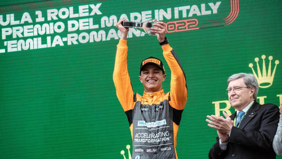 On the podium, McLaren's racer Lando Norris celebrates his third-place finish at Formula 1's 2022 Emilia Romagna Grand Prix.