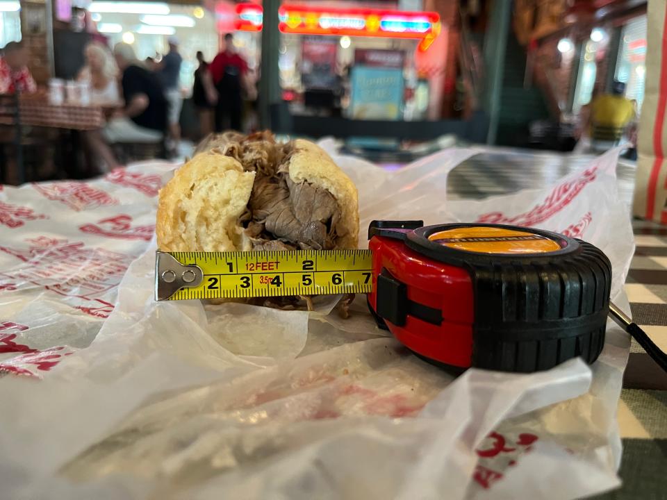 A tape measure showing the width of a Portillo's sandwich at 2 1/2 inches.