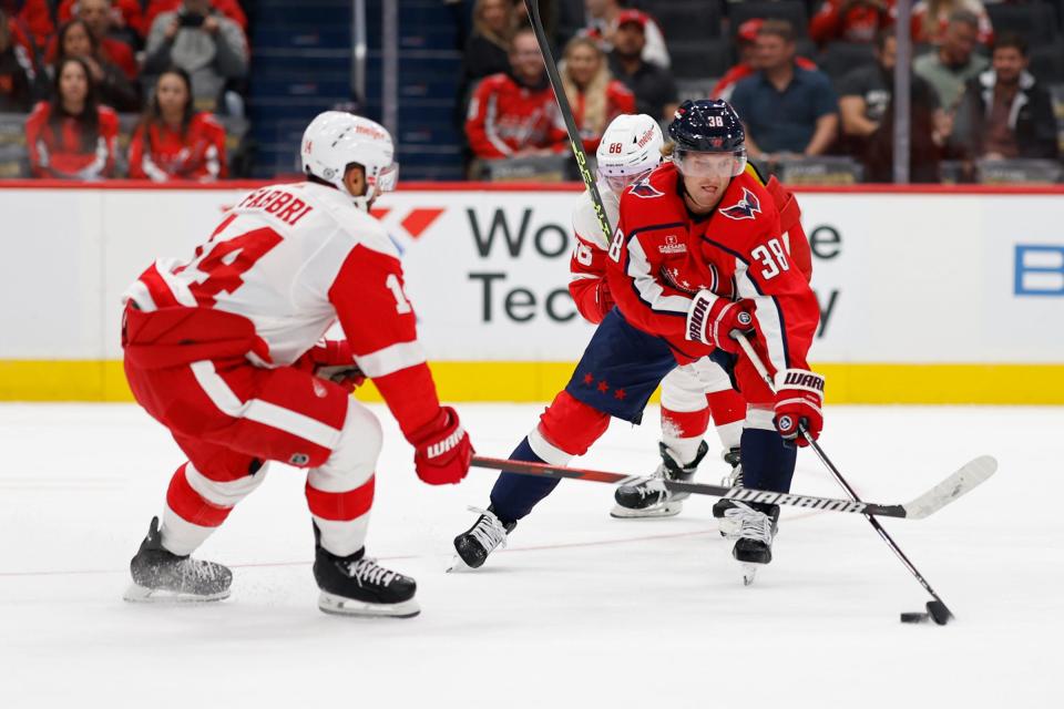 Capitals defenseman Rasmus Sandin skates with the puck as Red Wings center Robby Fabbri defends in the first period of the exhibition on Thursday, Sept. 28, 2023, in Washington.