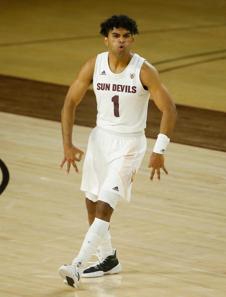 Feb. 27, 2021; Tempe, Arizona, USA; ASU's Remy Martin (1) reacts after hitting the game-winning three pointer during the overtime against Washington State at ASU. Mandatory Credit: Patrick Breen-Arizona Republic