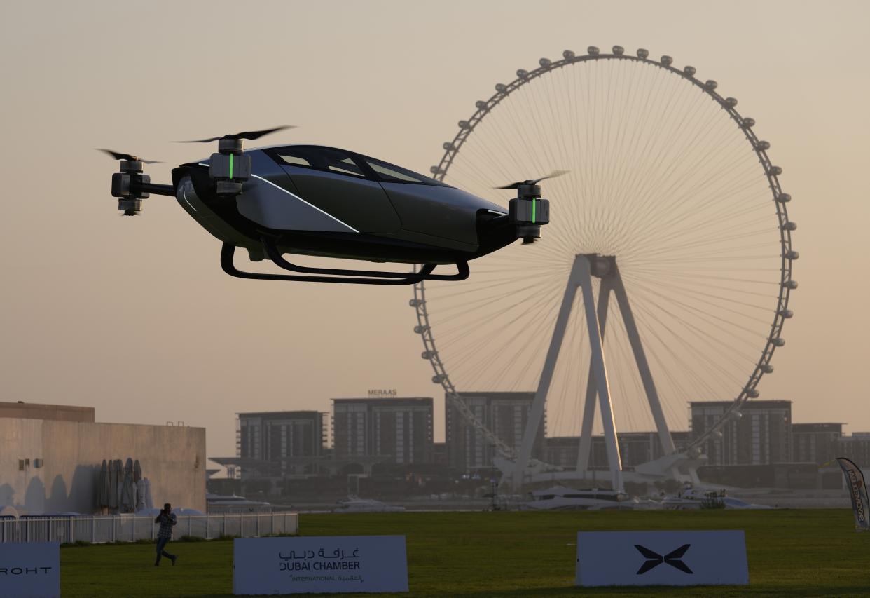 A XPeng X2, an electric flying taxi developed by the Guangzhou-based XPeng, Inc's aviation affiliate, is tested in front of the Marina District in Dubai, United Arab Emirates, Monday, Oct. 10, 2022. Monday’s demonstration was held with an empty cockpit, but the company says it carried out a manned flight test last year of the two-passenger vehicle. (AP Photo/Kamran Jebreili)