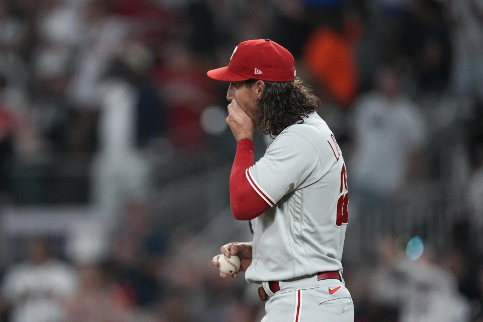 Philadelphia Phillies relief pitcher Michael Lorenzen reacts on the mound after giving up a two-run double to Atlanta Braves designated hitter Marcell Ozuna in the fifth inning of a baseball game Tuesday, Sept. 19, 2023. (AP Photo/John Bazemore)