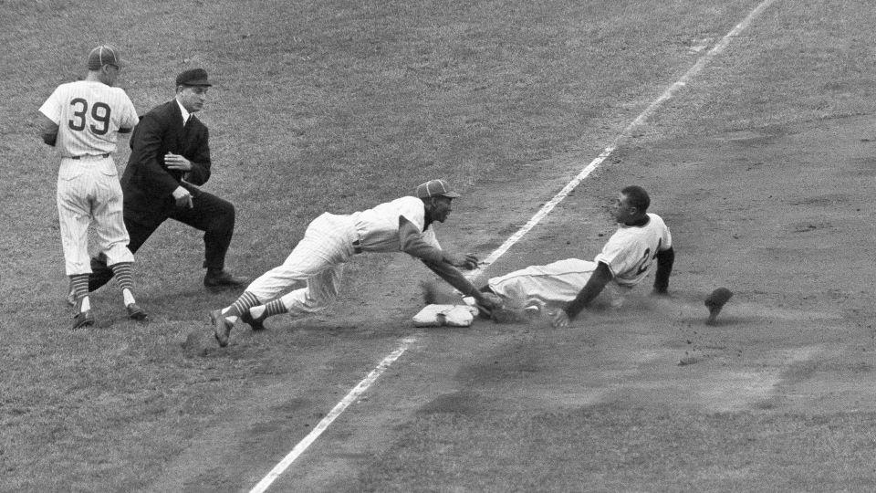 New York Giants star Willie Mays loses his hat as the slides into third, starting at first on an infield hit in the sixth inning of game against the Chicago Cubs on May 22, 1957, in Chicago. - Harry Hall/AP