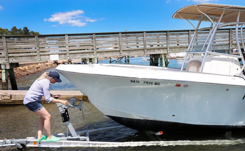 Shannon Robichaud, of Norwell, launches the family boat at the Jericho Road boat ramp in Scituate on Wednesday, June 29, 2022.