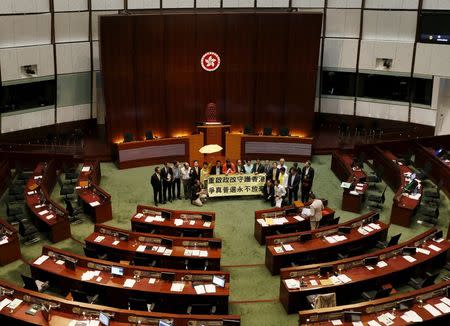 Pro-democracy lawmakers chant slogans after voting at Legislative Council in Hong Kong, China June 18, 2015. REUTERS/Bobby Yip