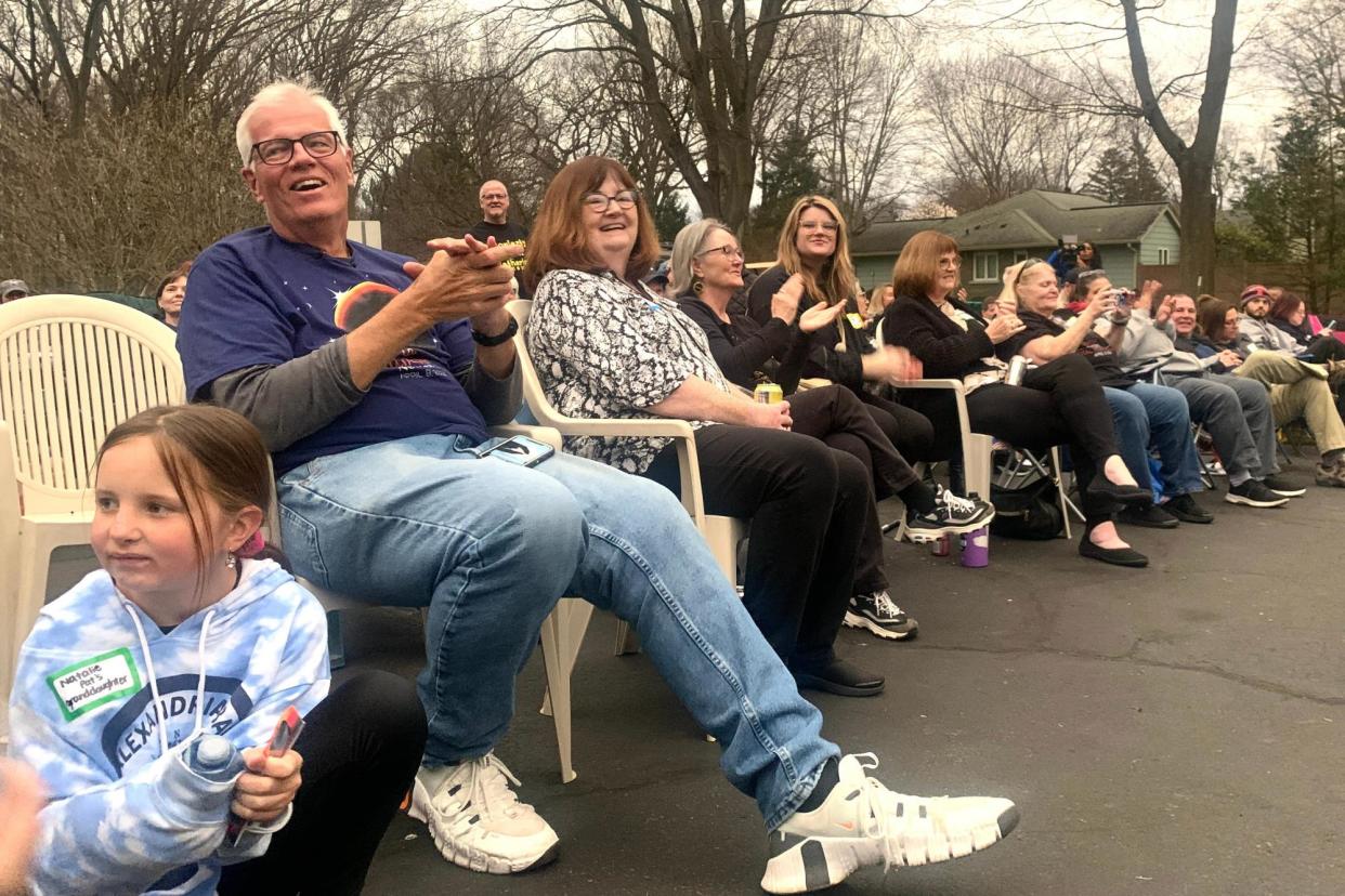 <span>Patrick Moriarty, left, watches the eclipse with his former students in his driveway in Brighton, New York, on 8 April 2024.</span><span>Photograph: Sarah Taddeo/Democrat and Chronicle via USA TODAY Network</span>