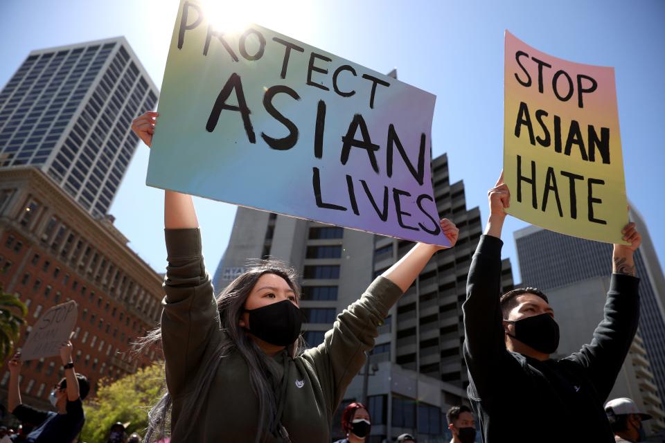 Protesters held signs during a March rally in San Francisco at which hundreds of people marched through downtown to show solidarity with Asian Americans, who have been the targets of hate crimes across the United States. (Photo by Justin Sullivan/Getty Images) ***BESTPIX*** ORG XMIT: 775636267 ORIG FILE ID: 1309328004