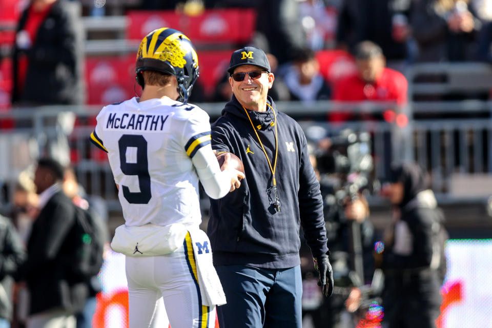 Michigan head coach Jim Harbaugh (right), talks with quarterback J.J. McCarthy prior to a matchup against Ohio State on Nov. 26, 2022, at Ohio Stadium in Columbus, Ohio. (Photo by Frank Jansky/Icon Sportswire via Getty Images)