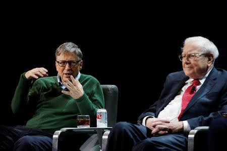 Bill Gates speaks while Warren Buffett, chairman and CEO of Berkshire Hathaway, looks on at Columbia University in New York, U.S., January 27, 2017. REUTERS/Shannon Stapleton