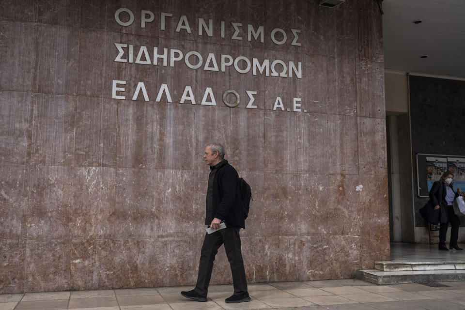 A man walks in front of the main train station during a strike in Athens, Greece, Thursday, March 2, 2023. Railway workers' associations called strikes that halted national rail services and the subway in Athens on Thursday, to protest working conditions and what they describe as a lack of modernization of the Greek rail system. (AP Photo/Petros Giannakouris)