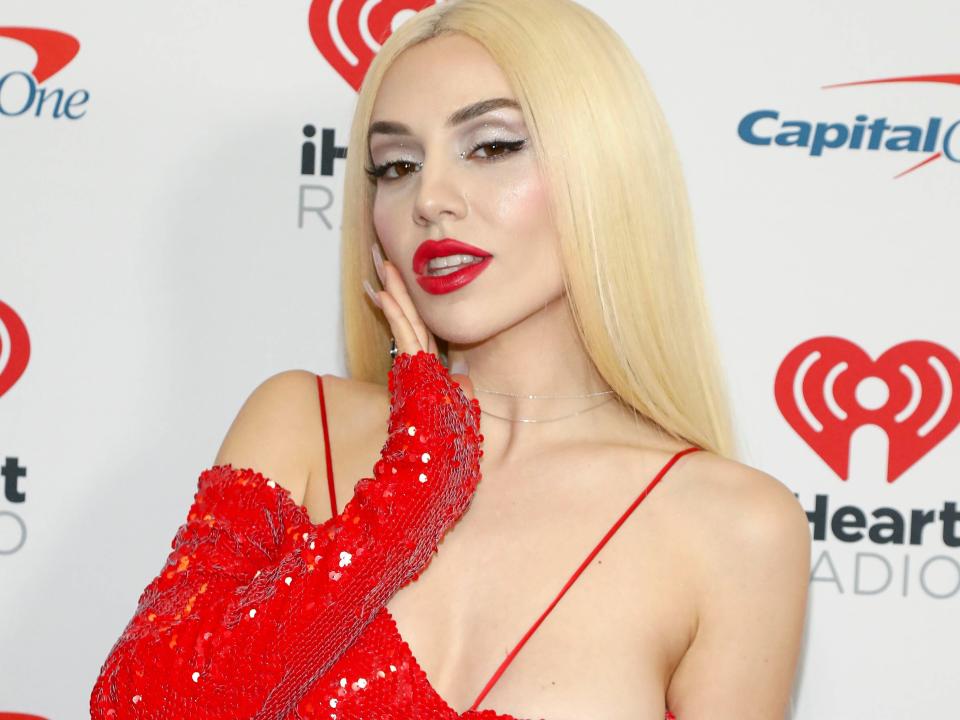 Ava Max wearing a red dress in December 2022.