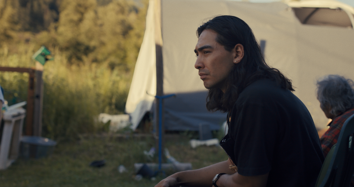 Sugarcane co-director Julian Brave NoiseCat is seen seated outdoors.