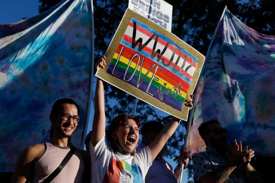 Caro Caden, center, and many others from the Athens Pride and Queer Collective, block protesters against the APQC's Athens Pride Week Kids and Youth Night Drag Story Hour outside of Hendershot's Coffee in Athens, Ga., on Wednesday, Sept. 14, 2022.