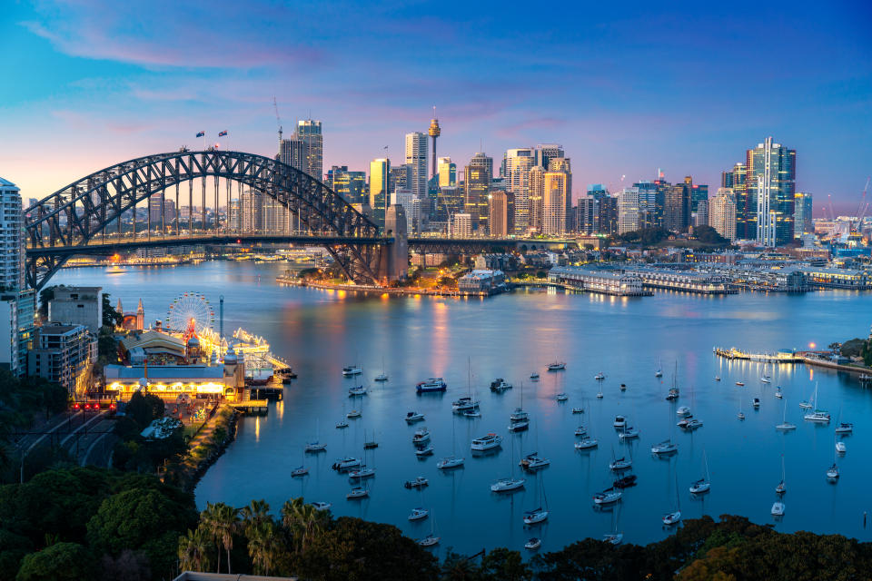 Cityscape image of Sydney, Australia with Harbor Bridge and Sydney skyline during sunset. Vacation and travel in Australia.