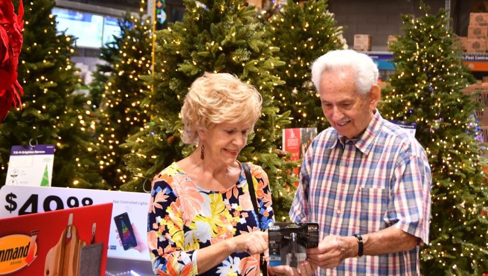 At the Lowe's home-improvement store in Indian Harbour Beach, Beth Joe Green and Douglas Park look for timers for their holiday lights.