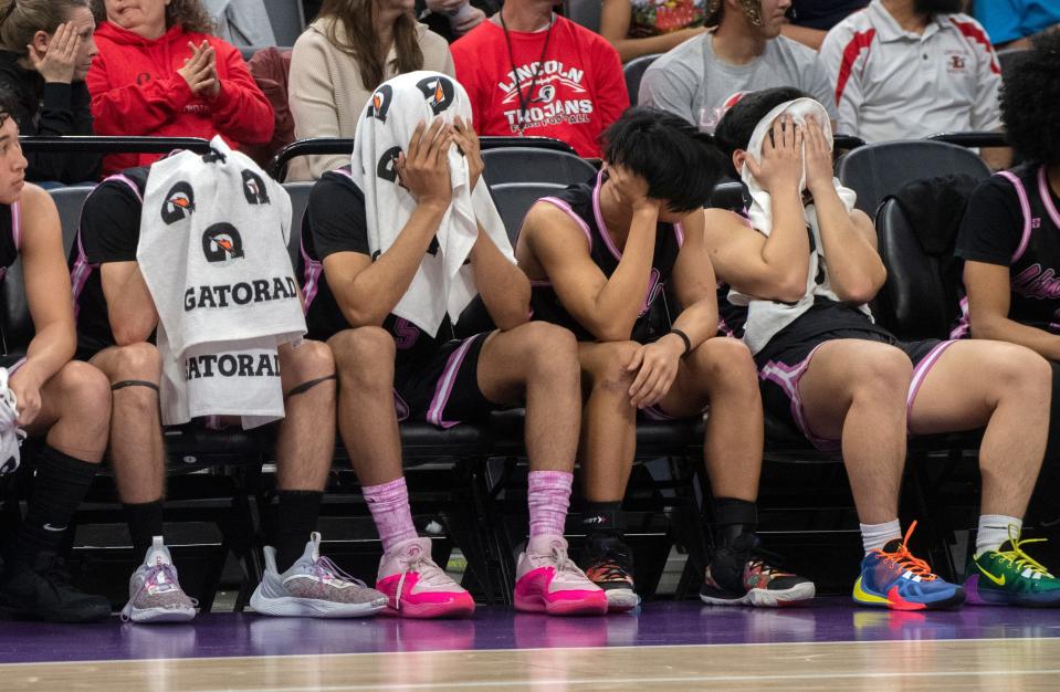 The Lincoln boys varsity basketball team reacts to losing 68-63 to Modesto Christian in the Sac-Joaquin Section championship game at Golden One Center in Sacramento on Feb. 21. 2024.