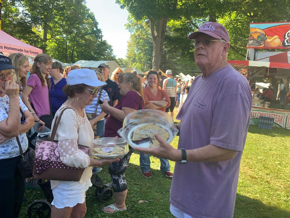 Again this year, the World's Greatest Grape Pie Contest will take place during the Naples Grape Festival on Sept. 24-25. In this file photo, Bruce Scott auctions off grape pies.