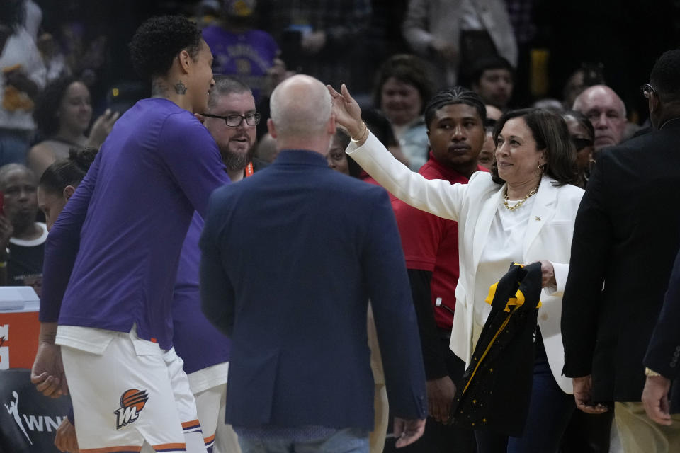 Phoenix Mercury center Brittney Griner (42) is greeted by Vice President Kamala Harris before a WNBA basketball game in Los Angeles, Friday, May 19, 2023. (AP Photo/Ashley Landis)