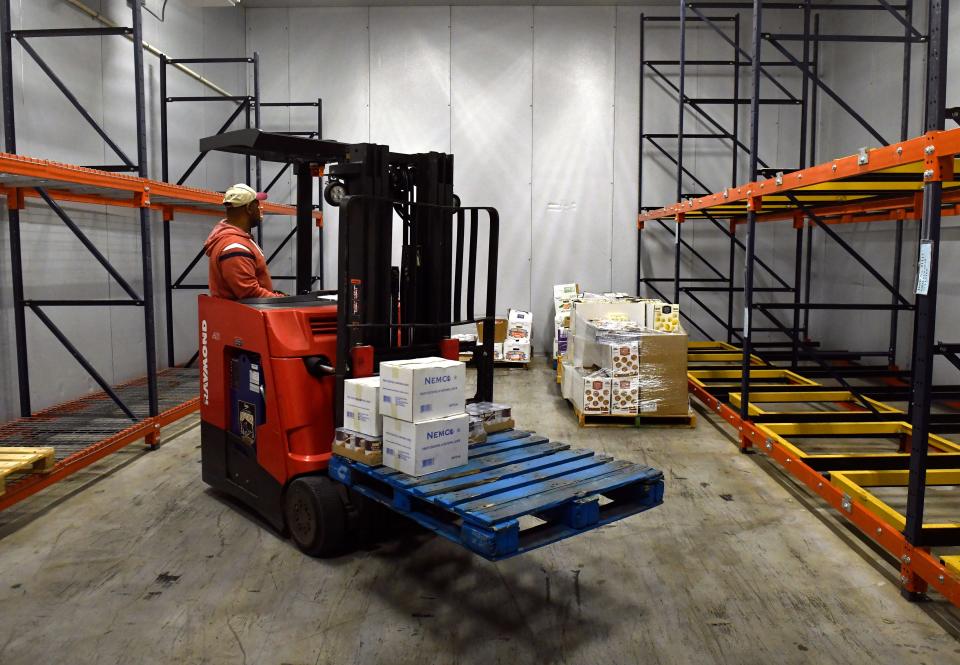 Nate Mays, the warehouse assistant manager at Food Bank of West Central Texas, loads refrigerated items onto a pallet last year.