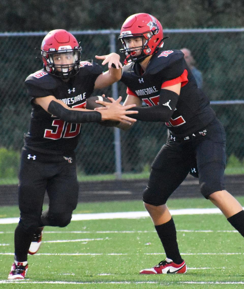 Honesdale's Aiden Collins (12) and Gabe Duda (36) look to execute the RPO during early season Lackawanna Football Conference action.