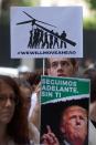 <p>Greenpeace protesters stand in silence with banners outside the U.S. embassy in Madrid, Spain, Friday, June 2, 2017. The protesters gathered at the gates of the United States embassy in the Spanish capital to protest President Donald Trump’s decision to pull the world’s second-largest carbon dioxide emitter out of the Paris climate agreement. (AP Photo/Paul White) </p>