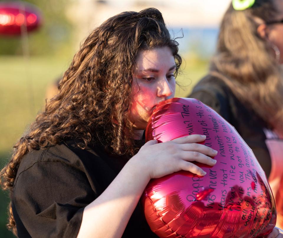 Kerestyn Clendenin reflects on her grandfather, Michael Broad, before a balloon release marking the 20th anniversary of his unsolved homicide. Her grandfather nicknamed her "Ladybug."