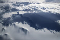 <p>Mountains peek through land ice as seen from NASA’s Operation IceBridge research aircraft in the Antarctic Peninsula region, on Nov. 4, 2017, above Antarctica. (Photo: Mario Tama/Getty Images) </p>