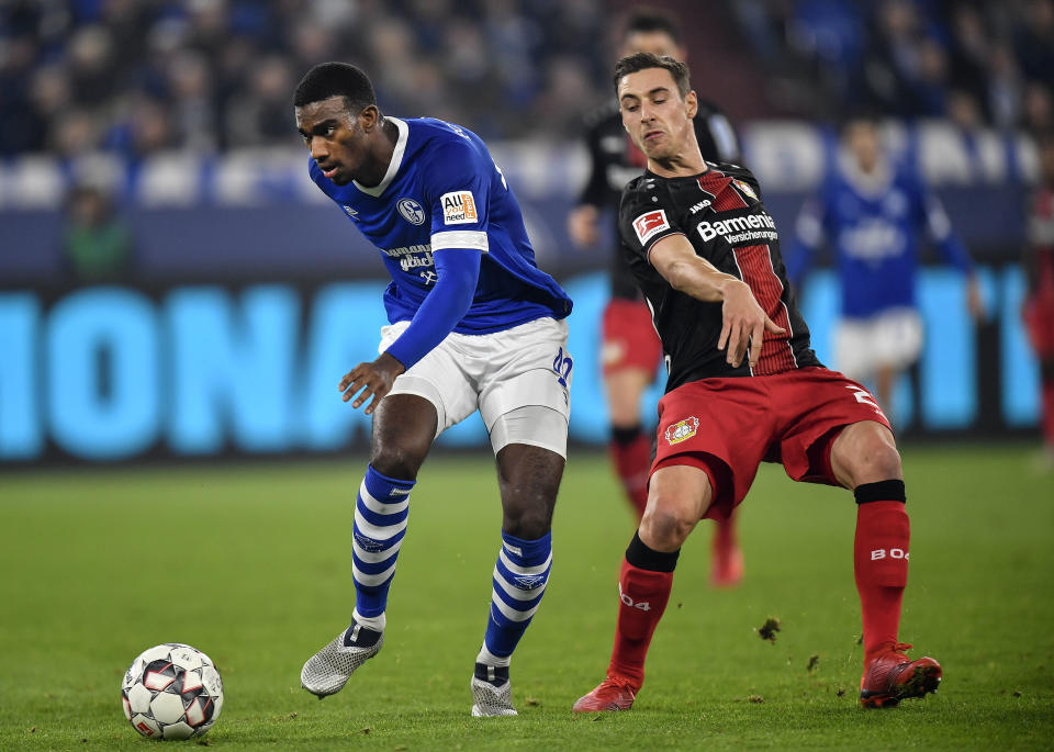 FILE - Schalke's Haji Wright, left, and Bayer Leverkusen's Dominik Kohr challenge for the ball during the German Bundesliga soccer match in Gelsenkirchen, Germany, Dec. 19, 2018. Wright, a 24-year-old forward from Los Angeles who is on a scoring run in the Turkish league, also is among the players who could make their United States debuts along with Borussia Mönchengladbach outside back Joe Scally, who was on the roster for November World Cup qualifiers but did not get in a match. (AP Photo/Martin Meissner, File)