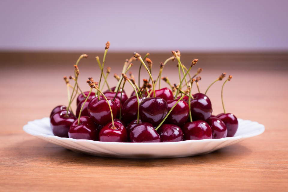 Sweet cherries in the white plate. Closeup