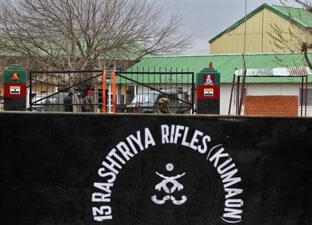 An Indian Army soldier keeps guard at the entrance of their camp in Safa Pora, north of Srinagar, February 27, 2014. REUTERS/Danish Ismail