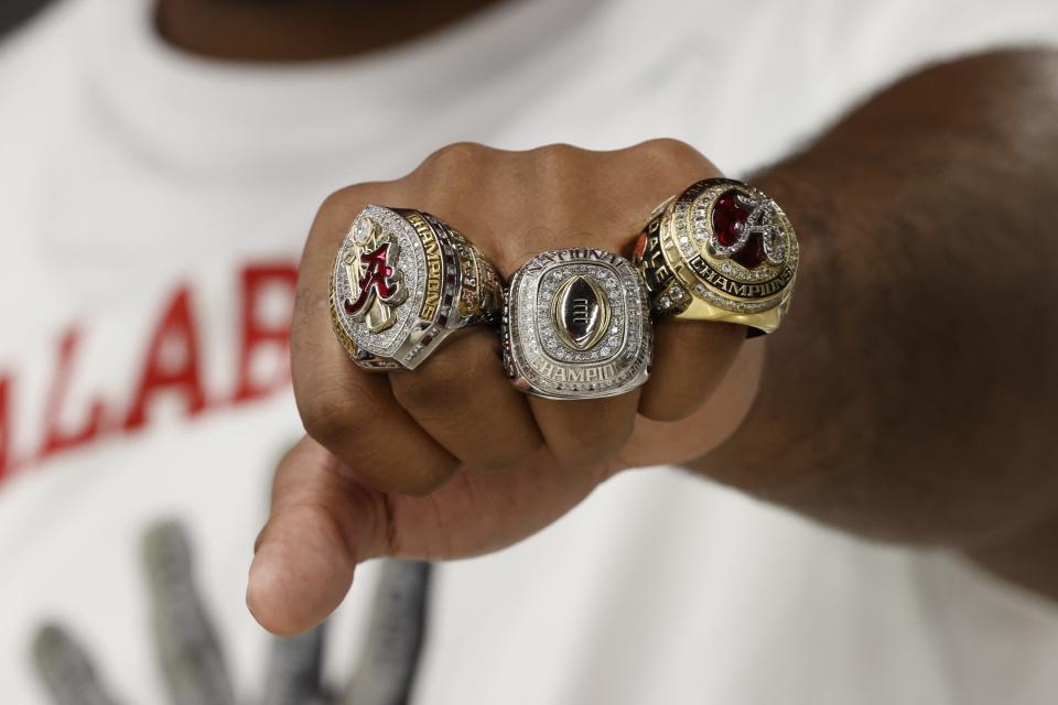 Alabama defensive lineman DJ Dale shows off his new championship rings.