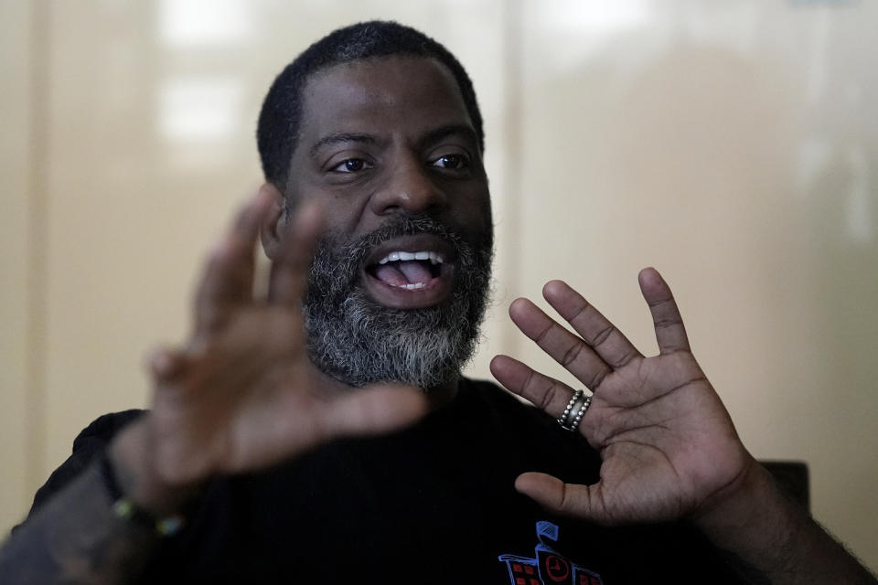 Chicago School Board candidate, rapper Che "Rhymefest" Smith, responds to question during an interview with The Associated Press, at his home in the Chatham neighborhood of Chicago, Tuesday, May 21, 2024. The nation's third-largest city is preparing for its first-ever school board elections and the slate of potential candidates include progressive activists, an afterschool squash program leader and a Grammy-winning rapper. (AP Photo/Charles Rex Arbogast)