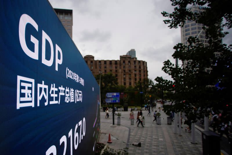 FILE PHOTO: An electronic display showing the China GDP indexes is seen on a street in Shanghai
