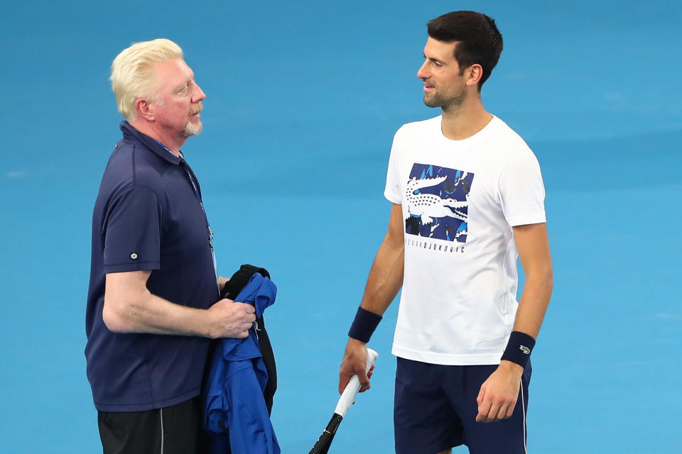 Boris Becker (pictured left) and Novak Djokovic (pictured right) talk during training.