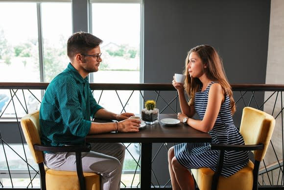 Couple sitting across from each other at a table