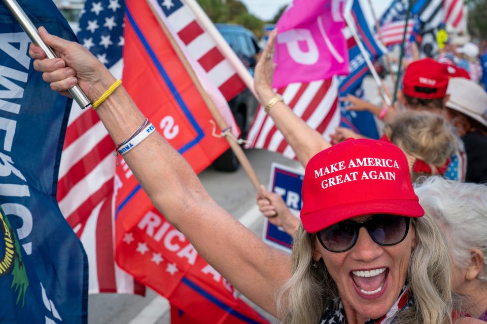 Supporters rally along the motorcade route waiting for former President Donald Trump to return home to Mar-a Lago following his arraignment in New York on April 4, 2023. 