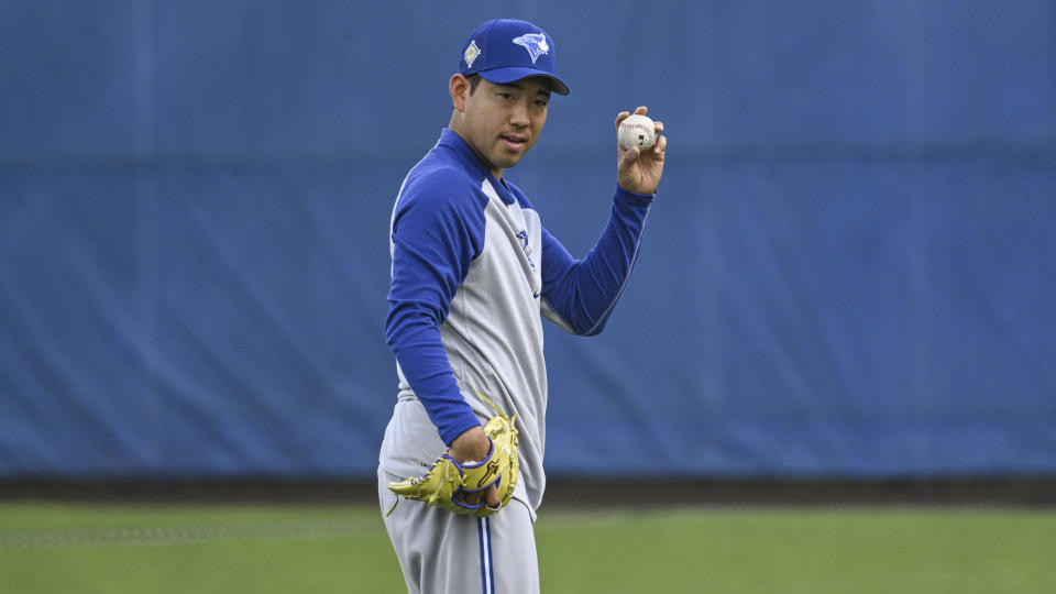 Toronto Blue Jays pitcher Yusei Kikuchi loosens up during a spring training baseball workout, Wednesday, March 16, 2022, in Dunedin, Fla. (Steve Nesius/The Canadian Press via AP)