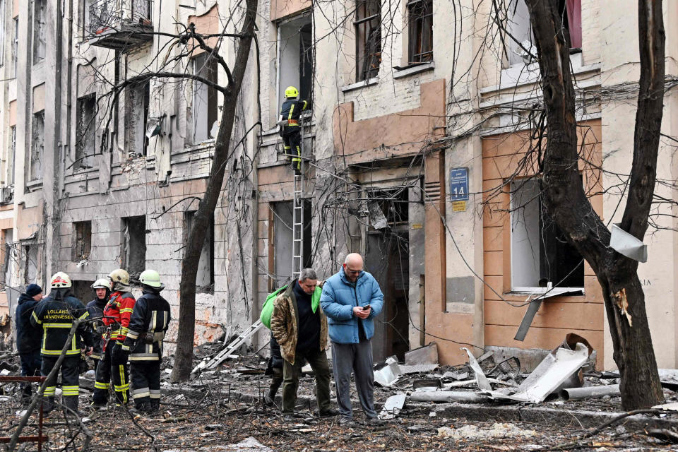 Rescuers are at work outside a building partially destroyed by Russian missile strike in Kharkiv, Ukraine (Sergey Bobok / AFP via Getty Images)