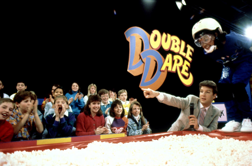 "Double Dare" host Marc Summers instructs a contestant during an episode. (© MTV/Courtesy of the Everett Collection)