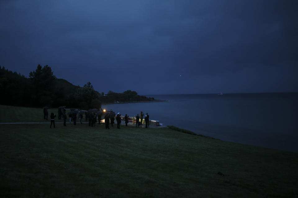 Dignitaries and military personnel attend the Dawn Service ceremony at the Anzac Cove beach in Gallipoli peninsula, the site of World War I landing of the ANZACs (Australian and New Zealand Army Corps) on April 25, 1915, in Canakkale, Turkey, early Sunday, April 25, 2021. The dawn service ceremony and all other commemorative ceremonies for the 106th anniversary honouring thousands of Australians and New Zealanders who fought in the Gallipoli campaign of World War I on the ill-fated British-led invasion, were small and held without public this year due to the coronavirus pandemic.(AP Photo/Emrah Gurel)