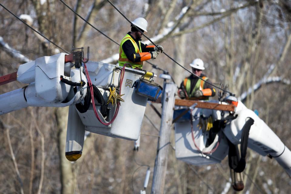 Linesmen work to restore electrical power, Friday, Feb. 7, 2014, in Downingtown, Pa. A small army of electricity restoration crews labored Friday to reconnect about 330,000 customers in Pennsylvania and Maryland. (AP Photo/Matt Rourke)