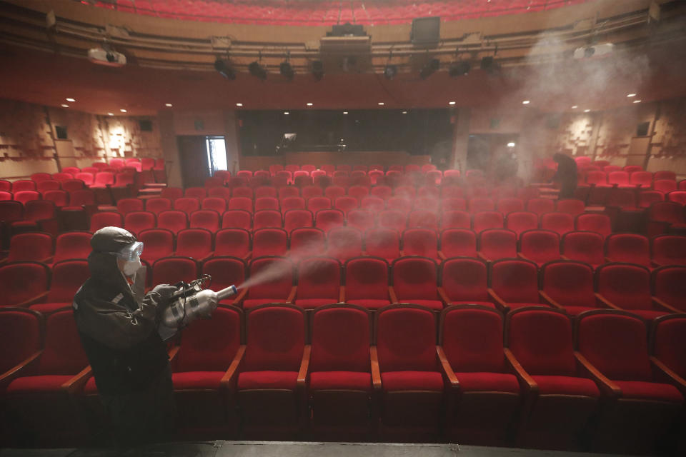 A worker wearing a protective gear sprays disinfectant as a precaution against a new coronavirus at a theater in Sejong Center in Seoul, South Korea, Tuesday, July 21, 2020. South Korea’s new virus cases have bounced back Tuesday, a day after it reported its smallest daily jump in local COVID-19 transmissions in two months. (AP Photo/Ahn Young-joon)