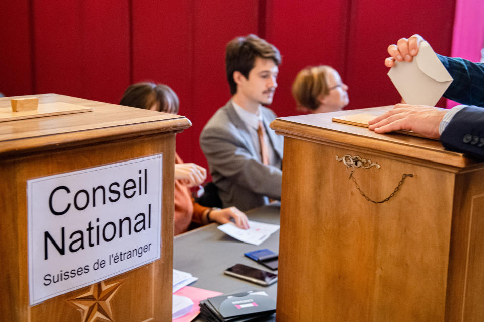 People are voting in the municipal office in Sion, Swizerland, on Sunday, Oct.20, 2019, during the 2019 Swiss Federal elections. (Olivier Maire/Keystone via AP)