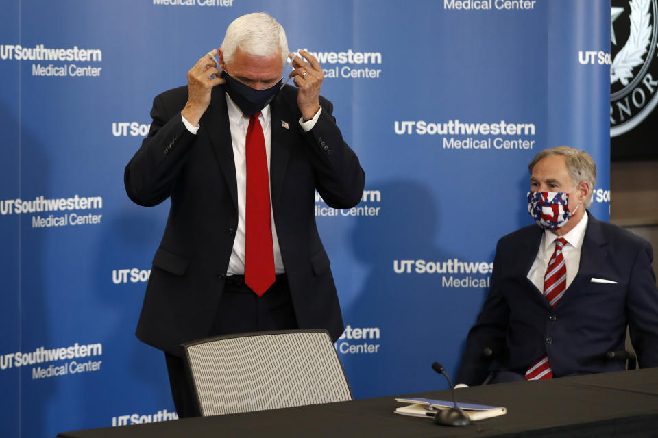 Vice President Mike Pence adjusts his mask as he and Texas Gov. Greg Abbott prepare to depart a news conference after Pence met with Abbott and members of his healthcare team regarding COVID-19 at the University of Texas Southwestern Medical Center West Campus in Dallas, Sunday, June 28, 2020. (Tony Gutierrez/AP Photo)