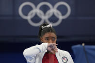 Simone Biles, of the United States, watches gymnasts perform at the 2020 Summer Olympics, Tuesday, July 27, 2021, in Tokyo. Biles says she wasn't in right 'headspace' to compete and withdrew from gymnastics team final to protect herself. (AP Photo/Ashley Landis)