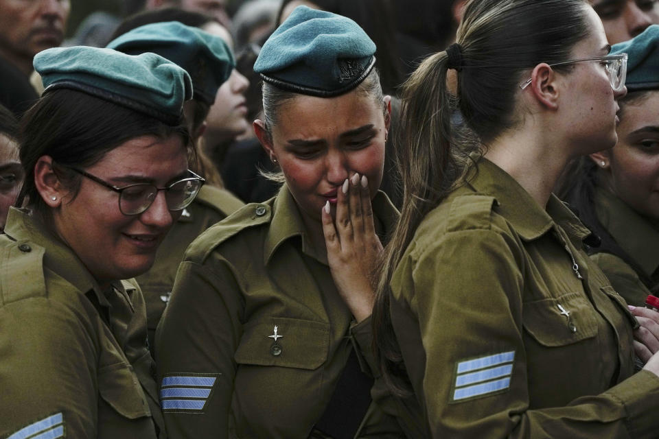 Israeli soldiers mourn during the funeral of Sgt. Yam Goldstein and her father, Nadav, in Kibbutz Shefayim, Israel, Monday, Oct. 23, 2023. Yam and her father were killed by Hamas militants on Oct. 7 at their house in Kibbutz Kfar Azza near the border with the Gaza Strip. The rest of the family are believed to be held hostage in Gaza. More than 1,400 people were killed and some 200 captured in an unprecedented, multi-front attack by the militant group that rules Gaza. (AP Photo/Ariel Schalit)