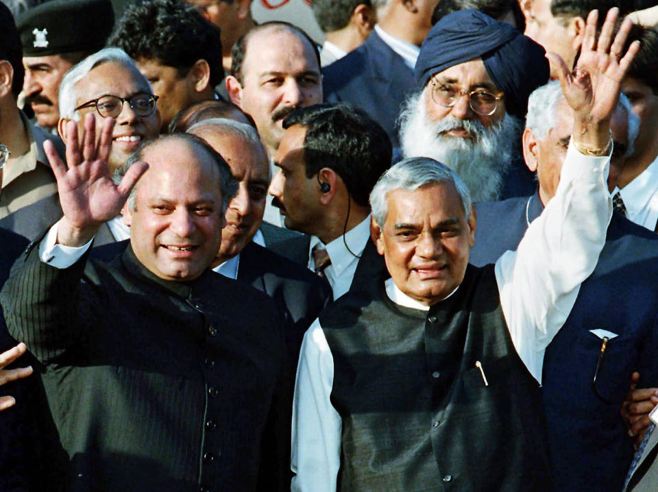 FILE - Pakistani Prime Minister Nawaz Sharif, left, and his Indian counterpart Atal Bihari Vajpayee wave upon Vajpayee's arrival in Wagha border, 28 kilometers (17 miles) from Lahore, Pakistan, Saturday, Feb. 20, 1999. Vajpayee arrived for talks with Sharif to pave a way to mend the deteriorated bi-lateral relationship between the two nations for the first time since the both countries conducted nuclear testing last year. (AP Photo/B.K.Bangash, File)